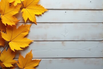 Autumn leaves on a white wooden background with copy space.