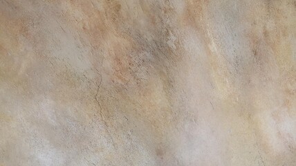 close up of a textured surface resembling weathered marble or stone, featuring a blend of soft beige, light brown, and gray tones. The surface is marked with subtle cracks and scratches.