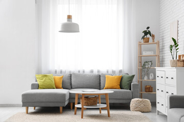Interior of living room with sofa and table near window