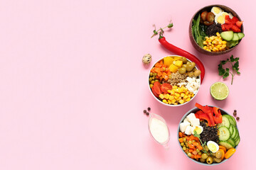 Bowls with different healthy quinoa salads on pink background