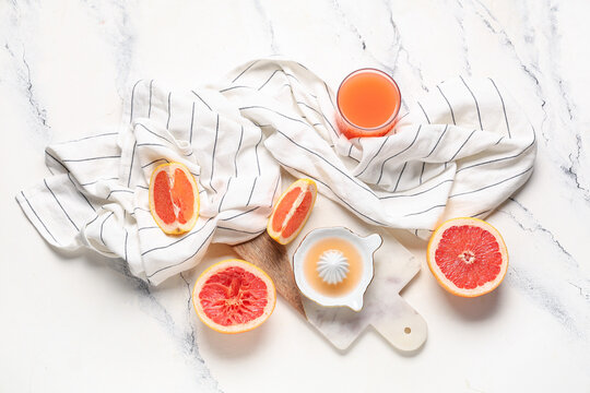 Composition with ceramic juicer with grapefruit juice on marble background - Powered by Adobe