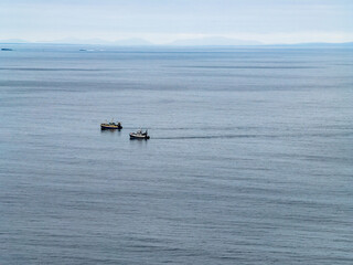 Two trawler pulling one big net to catch sprat in Donegal Bay within the six nautical mile zone, Ireland