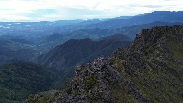 Circular aerial shot of the summit of Cerro Uran surrounded by a mountainous area full of paramo in Chirripo National Park in Costa Rica