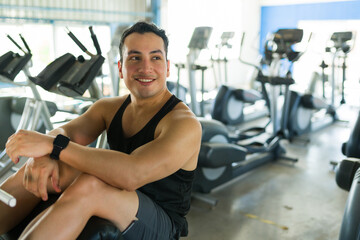 Fototapeta premium Man smiling taking break from gym workout