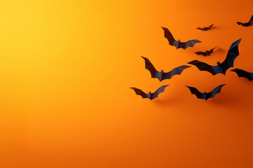 Halloween-style background with bats. Paper bats on an orange background. 