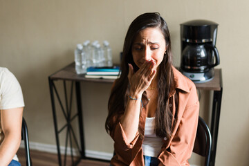 Woman crying during addiction support group session