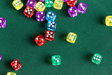 Different game dices on green background, closeup