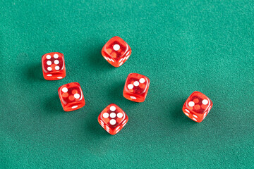 Composition with red game dices on green background, closeup