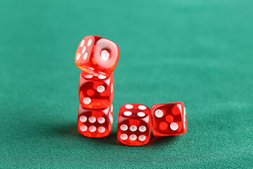 Red game dices on green background, closeup