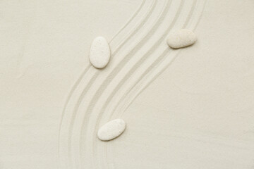 Beautiful composition with stones and lines on sand as background, closeup. Zen concept