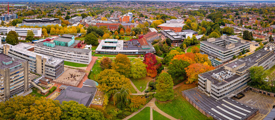 Drone shot of Southampton university buildings surrounded by colorful autumn trees and walking paths, ideal for education or seasonal campus lifestyle themes © Alexey Fedorenko