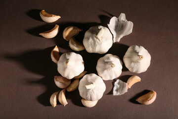 Many fresh garlics on brown background