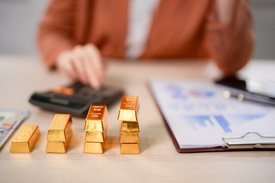 Adult investor analyzes gold investment calculations financial growth wealth management precious metals trading market assets future plan