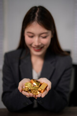 Asian adult woman holds gold bars gold coins representing wealth investment financial success for secure future prosperity