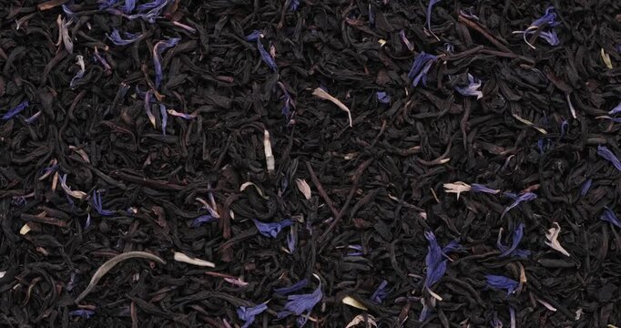 360 Rotative Top view footage of dried Earl Grey Black tea, White tea tips, white jasmine petals with blue cornflower petals
