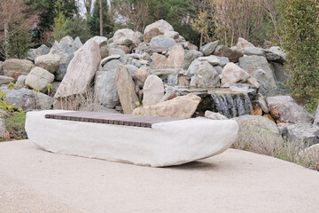 modern stone and wood bench in a japanese style garden