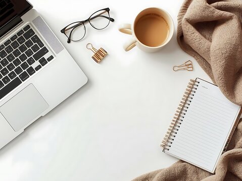Cozy workspace with laptop coffee notebook and glasses