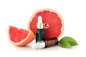 Bottles of grapefruit cosmetic oil and fruit on white background