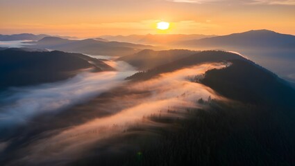Fototapeta premium Sunrise over misty mountains creates a beautiful and serene landscape in nature light