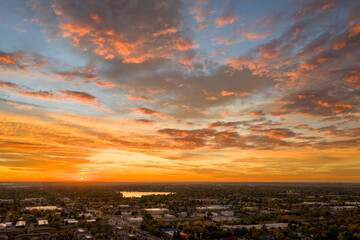 Fototapeta premium sunrise over midtown of Fort Collins and plains in northern Colorado, aerial view