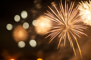 Fototapeta premium Spectacular fireworks display illuminates the night sky with brilliant golden bursts, creating a mesmerizing visual spectacle. Celebration moments in time captured!