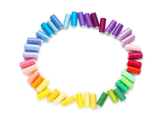Obraz premium Frame made of thread spools on white background