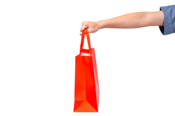 Hand holding empty red paper bag isolated on a transparent background.