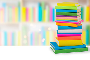 Books in multi-colored covers on an bookshelves. Literature for children. Collection in the library. Textbooks for school college or university