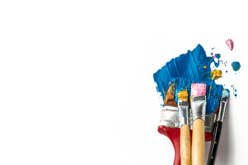 Old brushes with thick paints, acrylic or oil