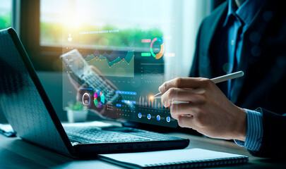 Business professional analyzing digital data dashboard with futuristic charts on laptop, representing financial analytics, business intelligence, digital transformation, data-driven decision making.