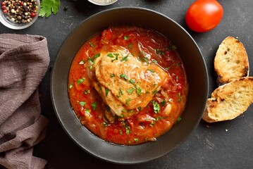 Baked chicken with tomato gravy and herbs