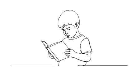 A young boy intently reads a book with a focused expression.