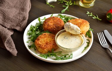 Delicious fish cakes from mashed potato and minced fish served with dipping sauce