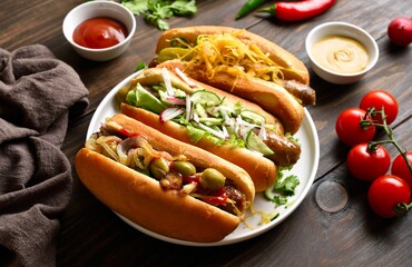 Hot dogs with different toppings on wooden table