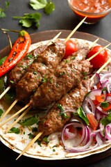 Grilled lula kebab with fresh vegetables on flat bread