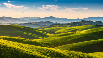Obraz premium Lush Green Rolling Hills Under Vibrant Sky During Golden Hour in Scenic Countryside
