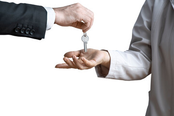 Hand of man in formal suit giving keys to woman's hand on isolated background. Concept of sale of real estate, rent of housing