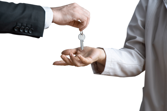 Hand of man in formal suit giving keys to woman's hand on isolated background. Concept of sale of real estate, rent of housing - Powered by Adobe
