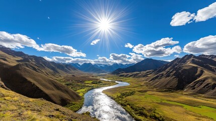 Scenic river winding through a valley amidst mountains under a vibrant sky.