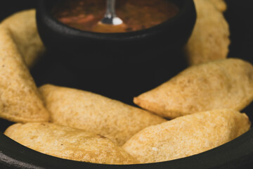 Colombian empanada with spicy sauce 