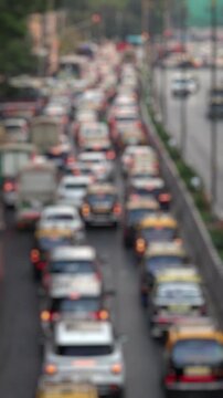 Bokeh view of road traffic near Chhatrapati Shivaji Maharaj Terminus (CSMT railway station) Mumbai, India. Blurred background footage.