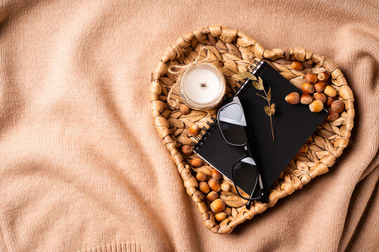 Autumn cozy setting with candle, book and glasses