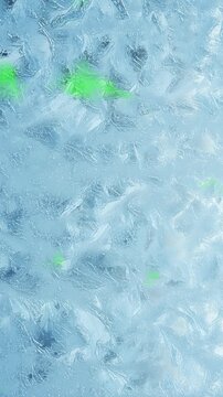 Frost crystals grow across a vivid green screen, perfect for winter transitions and overlays