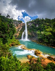 Lush tropical waterfall cascading into a turquoise pool, framed by dense jungle foliage and dramatic sky