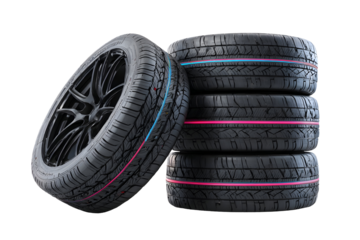 Balanced stack of four automotive tires on black background for vehicle maintenance and design