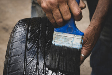 Mechanic working on the street fixing a car 