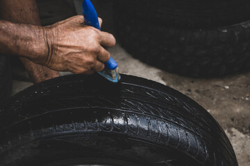 Mechanic working on the street fixing a car 