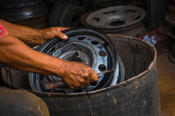 Mechanic working on the street fixing a car 