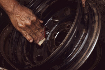Mechanic working on the street fixing a car 
