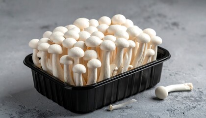 Fresh white mushrooms in black plastic container